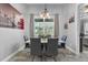 Chic dining room featuring a modern table with gray chairs, stylish light fixture, and London-themed decor at 2988 Sequoyah Dr, Haines City, FL 33844