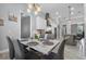 Airy dining room with modern table and chairs flowing seamlessly into the adjacent kitchen area at 2988 Sequoyah Dr, Haines City, FL 33844