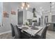 Well-lit dining area showcases a marble table, gray chairs, and decorative accents connecting to the kitchen at 2988 Sequoyah Dr, Haines City, FL 33844