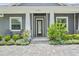 Welcoming front entrance with detailed stonework, a modern door, and lush landscaping at 2988 Sequoyah Dr, Haines City, FL 33844