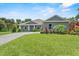 Inviting single-story home with well-maintained lawn and landscaping, showcasing the home's curb appeal at 2988 Sequoyah Dr, Haines City, FL 33844