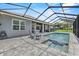 Relaxing pool with a spa surrounded by pavers and a screened-in lanai, perfect for outdoor enjoyment at 2988 Sequoyah Dr, Haines City, FL 33844