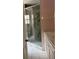 Bathroom features a glass door standing shower, toilet, and marble countertop with white cabinets at 300 E Washington St, Minneola, FL 34715