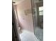 Cozy bathroom featuring a tile floor, shower, and convenient wall-mounted storage at 300 E Washington St, Minneola, FL 34715