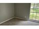 Bedroom featuring carpeted floors, natural light, and neutral wall color at 300 E Washington St, Minneola, FL 34715