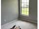 Bedroom featuring carpeted floors, natural light, and neutral wall color at 300 E Washington St, Minneola, FL 34715