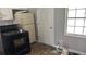 Functional kitchen featuring white cabinets, black appliances, and a window with a view at 300 E Washington St, Minneola, FL 34715