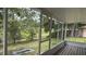 Relaxing screened porch with views of the lush backyard and mature trees at 300 E Washington St, Minneola, FL 34715