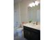 Cozy bathroom with a dark vanity, neutral walls, and a shower/tub combo at 3023 Caneel, Winter Haven, FL 33884