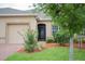 Charming single-story home featuring manicured landscaping and an attached two-car garage at 3023 Caneel, Winter Haven, FL 33884