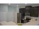 Modern kitchen with stainless steel appliances, dark cabinets, and quartz countertops at 3023 Caneel, Winter Haven, FL 33884