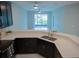 Open kitchen featuring dark cabinets, quartz countertops and view to the screened patio at 3023 Caneel, Winter Haven, FL 33884