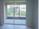 A view from inside, out to a screened patio with manicured landscaping at 3023 Caneel, Winter Haven, FL 33884