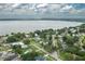 Aerial view of home in a lakeside community with lush green landscaping and mature trees at 304 W Lake Ave, Auburndale, FL 33823
