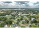 Aerial view of a residential area with mature trees and well-maintained lawns at 304 W Lake Ave, Auburndale, FL 33823