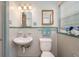 Clean bathroom featuring a sink, toilet, medicine cabinet, and shower with tile surround at 304 W Lake Ave, Auburndale, FL 33823