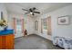 Comfortable bedroom features a ceiling fan, natural light from two windows, and neutral walls at 304 W Lake Ave, Auburndale, FL 33823