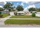 Charming single story home with well manicured lawn, attached garage, and covered front porch at 304 W Lake Ave, Auburndale, FL 33823