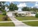 Charming single-story home with a well-maintained front yard, driveway, and attached garage at 304 W Lake Ave, Auburndale, FL 33823