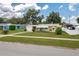 Exterior front yard shot of a single story home with lawn and sidewalk at 304 W Lake Ave, Auburndale, FL 33823