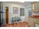 The dining area offers built-in cabinets and a refrigerator on the back wall, adjacent to the kitchen at 304 W Lake Ave, Auburndale, FL 33823