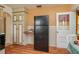 Kitchen view showcasing cabinetry, appliances, adjacent to the dining area, and access to the back door at 304 W Lake Ave, Auburndale, FL 33823