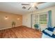 Spacious living room boasting hardwood floors, a front door, and a large window for ample natural light at 304 W Lake Ave, Auburndale, FL 33823