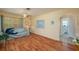Cozy living room featuring wood floors, a ceiling fan, and a glimpse into an adjacent bathroom at 304 W Lake Ave, Auburndale, FL 33823