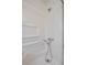 Stand-up shower with white tile surround and shower head at 304 W Lake Ave, Auburndale, FL 33823