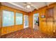 Sunroom with wood paneling, mosaic tile floors, and a glass door leading to an outside space at 304 W Lake Ave, Auburndale, FL 33823