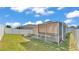A screened patio overlooks the fenced backyard and grassy lawn at 3173 Whispering Trails Ave, Winter Haven, FL 33884
