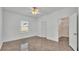 A bright bedroom with ceramic tile floors, closet, and view to another room at 3173 Whispering Trails Ave, Winter Haven, FL 33884