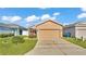 Charming single-Gathering home featuring a well-manicured lawn and an attached two-car garage at 3173 Whispering Trails Ave, Winter Haven, FL 33884
