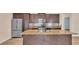 Modern kitchen with stainless steel appliances, dark cabinetry, and a large island at 3173 Whispering Trails Ave, Winter Haven, FL 33884