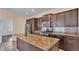 Modern kitchen with stainless steel appliances, dark cabinetry, and granite countertops at 3173 Whispering Trails Ave, Winter Haven, FL 33884