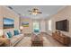 Cozy living room with stylish furniture, wood-look floors, and plenty of natural light at 3173 Whispering Trails Ave, Winter Haven, FL 33884