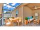 The screened patio is comfortably furnished with a dining table and cushioned sofa at 3173 Whispering Trails Ave, Winter Haven, FL 33884