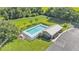 Aerial view of a community pool and pool house with a parking lot at 3173 Whispering Trails Ave, Winter Haven, FL 33884