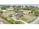 Aerial view showing the house, with solar panels, fenced yard, and partial lake view at 326 Sunset Rd, Frostproof, FL 33843