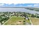 This aerial view showcases properties surrounding the lake at 326 Sunset Rd, Frostproof, FL 33843