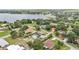 This aerial view of the property showcases a neighborhood near a lake at 326 Sunset Rd, Frostproof, FL 33843