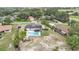 This aerial view showcases a home with solar panels and a fenced backyard pool and yard at 326 Sunset Rd, Frostproof, FL 33843