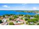 Beautiful aerial view of the house with a pool, waterfront access, and lush greenery at 326 Sunset Rd, Frostproof, FL 33843