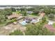 This aerial view showcases a home with a fenced backyard pool and ample backyard space at 326 Sunset Rd, Frostproof, FL 33843