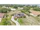 Aerial view of the house featuring solar panels, an extended driveway, and fenced yard at 326 Sunset Rd, Frostproof, FL 33843