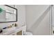 Bathroom with white vanity and commode; shower is not visible from this angle at 326 Sunset Rd, Frostproof, FL 33843