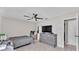Bedroom with tile floors, neutral wall paint, ceiling fan, and view into hallway at 326 Sunset Rd, Frostproof, FL 33843
