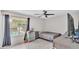 Bright bedroom with tile floors, a ceiling fan, and a view of the pool outside the window at 326 Sunset Rd, Frostproof, FL 33843