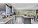 Kitchen view with island bar and dark cabinets, providing ample counter space and natural light at 326 Sunset Rd, Frostproof, FL 33843