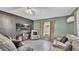 Cozy living room featuring tile flooring, an entertainment center and comfortable seating at 326 Sunset Rd, Frostproof, FL 33843